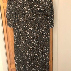 Below the knee dress with pleats on lower end.